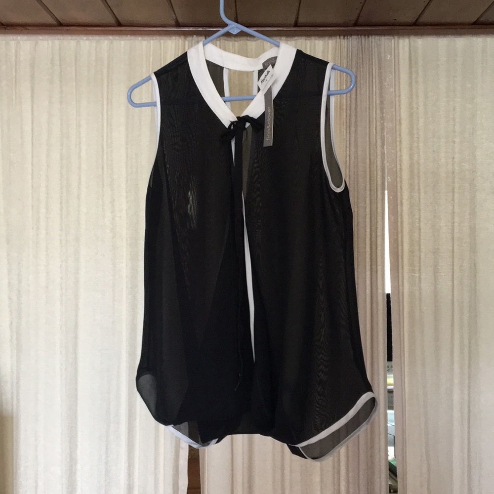 Gorgeous criss-cross sheer sleeveless elegant top.